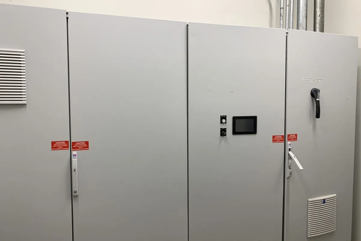 Large gray commercial switchgear cabinets with a digital meter display