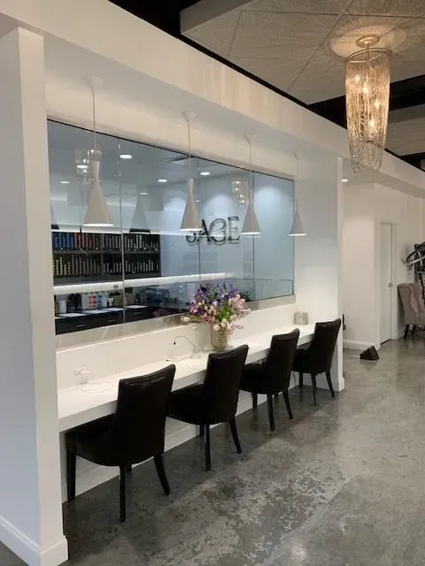 A row of chairs and counter with a window displaying the word